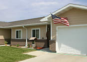 Thumbnail 2 of 3 - A house with a flag on the roof.