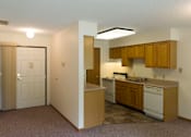 Thumbnail 2 of 6 - A kitchen area with a sink, stove, and cabinets.