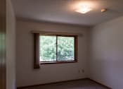 Thumbnail 4 of 6 - A room with a window and a ceiling light.