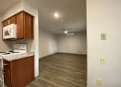 Thumbnail 4 of 12 - A kitchen with a microwave, oven, and stove top.
