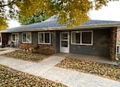 Thumbnail 1 of 12 - A house with a grey roof and a grey garage door.
