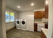 Thumbnail 11 of 12 - A laundry room with a washer and dryer.