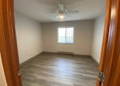 Thumbnail 6 of 12 - A room with a ceiling fan and a window with blinds.