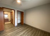 Thumbnail 7 of 12 - A room with a light brown wooden floor and white walls.