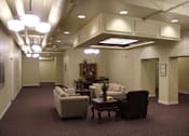 Thumbnail 3 of 11 - A living room with a couch, chairs, and a coffee table.