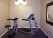Thumbnail 4 of 11 - A room with a mirror and exercise equipment.