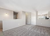 Thumbnail 7 of 25 - A spacious living room with a carpeted floor and a window.