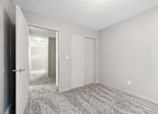 Thumbnail 13 of 25 - A room with a carpeted floor and two doors.