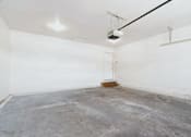 Thumbnail 25 of 25 - A room with a concrete floor and a door on the left side.