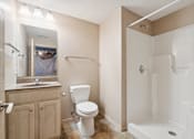 Thumbnail 19 of 25 - A white toilet sits in a bathroom next to a sink and a bathtub.