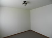 Thumbnail 5 of 7 - A room with a light fixture on the ceiling and two switches on the wall.