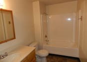 Thumbnail 7 of 7 - A white toilet sits next to a white sink in a bathroom.