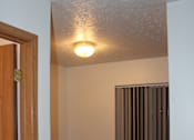 Thumbnail 7 of 13 - A white wall with a light on it.