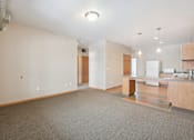Thumbnail 4 of 30 - A spacious room with a kitchenette and a dining area.