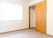 Thumbnail 16 of 19 - A room with a wooden door and a window with blinds.
