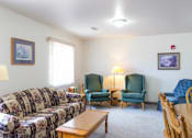 Thumbnail 4 of 19 - A living room with a sofa, chairs, and a coffee table.