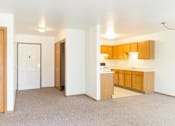 Thumbnail 8 of 19 - A kitchen area with wooden cabinets and a countertop.