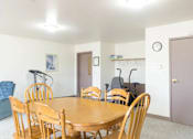 Thumbnail 6 of 19 - A dining room with a wooden table and chairs.