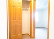 Thumbnail 13 of 19 - A white room with a wooden door.