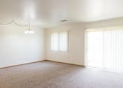 Thumbnail 11 of 19 - A room with a carpeted floor and a window with blinds.