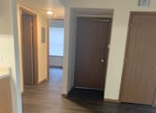 Thumbnail 3 of 6 - A wooden cabinet with a black object on top is mounted on a wall with wood paneling.