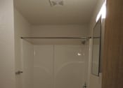 Thumbnail 9 of 11 - A white toilet and sink in a small bathroom.