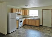 Thumbnail 3 of 7 - A kitchen with a refrigerator, oven, sink and cabinets.