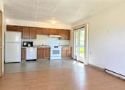 Thumbnail 2 of 21 - an empty kitchen with white appliances and wooden cabinets