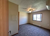 Thumbnail 8 of 10 - an empty room with a ceiling fan and a window