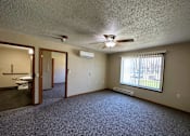 Thumbnail 7 of 10 - an empty living room with a large window and a ceiling fan