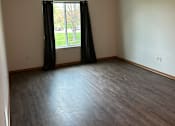 Thumbnail 3 of 12 - A small window with black blinds is on a white wall.