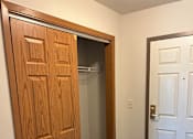 Thumbnail 7 of 12 - A wooden door with a handle is open to a small room.