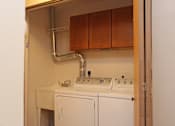 Thumbnail 10 of 11 - A white sink and dishwasher in a small kitchen.
