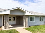 Thumbnail 1 of 12 - A house with a grey siding and a white roof.