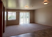 Thumbnail 3 of 16 - A living room in a two bedroom, one story apartment.