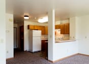 Thumbnail 12 of 16 - A kitchen with white appliances and wooden cabinets.