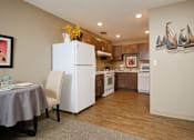 Thumbnail 3 of 14 - a kitchen with a white refrigerator freezer next to a white stove top oven