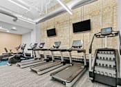 Thumbnail 26 of 45 - Fitness Center with cardio and weight-lifting equipment and free weights at The Cosmopolitan, Minnesota, 55101