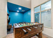 Thumbnail 32 of 45 - Game room with billiards, foosball, lounge chairs, darts, and TVs at The Cosmopolitan, St Paul, 55101