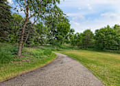 Thumbnail 23 of 25 - a path through a grassy area with trees on either side  at Shadow Hills, Plymouth, MN, 55442