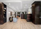 Thumbnail 11 of 30 - A modern interior with wood floors and furniture.