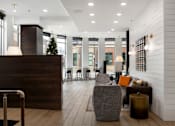 Thumbnail 14 of 22 - A reception area with a wooden desk and a chair.
