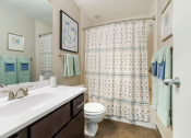 Thumbnail 11 of 25 - a bathroom with a shower and a sink and a toilet  at The Cosmopolitan, St Paul, Minnesota