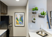 Thumbnail 8 of 25 - kitchen with stainless steel appliances and white countertops at theolan apartments
