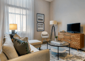 Thumbnail 4 of 25 - a living room with a couch and a television  at The Cosmopolitan, St Paul, MN, 55101