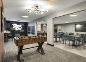 Thumbnail 15 of 18 - a game room with a foosball table and a tv  at Cedars Lakeside, Little Canada, Minnesota