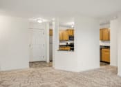 Thumbnail 8 of 45 - the living room and kitchen of an empty apartment with white walls and wood cabinets at Cityscape, St Louis Park, MN, 55416