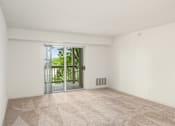 Thumbnail 10 of 45 - an empty living room with a sliding glass door to a balcony at Cityscape, St Louis Park, MN, 55416