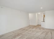 Thumbnail 9 of 45 - the living room and kitchen of an apartment with white walls and flooring at Cityscape, St Louis Park, 55416