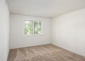 Thumbnail 13 of 45 - an empty room with carpet and a window at Cityscape, St Louis Park, Minnesota